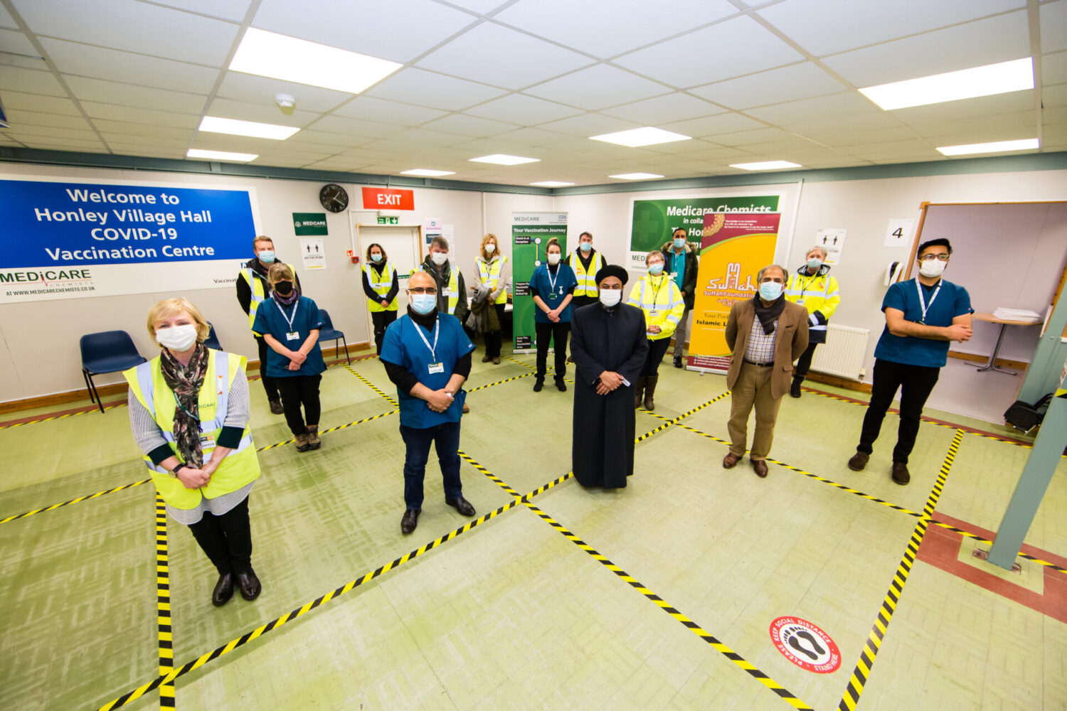Imam Umar Hayat and the team from the vaccination centre in Honley. They are all standing socially distanced.