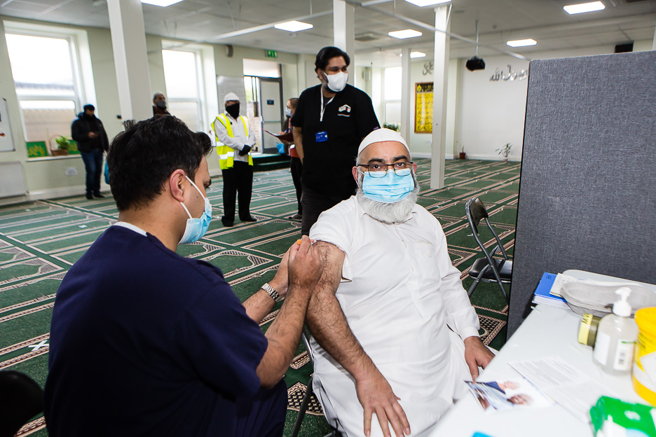 Man receives vaccine in right arm